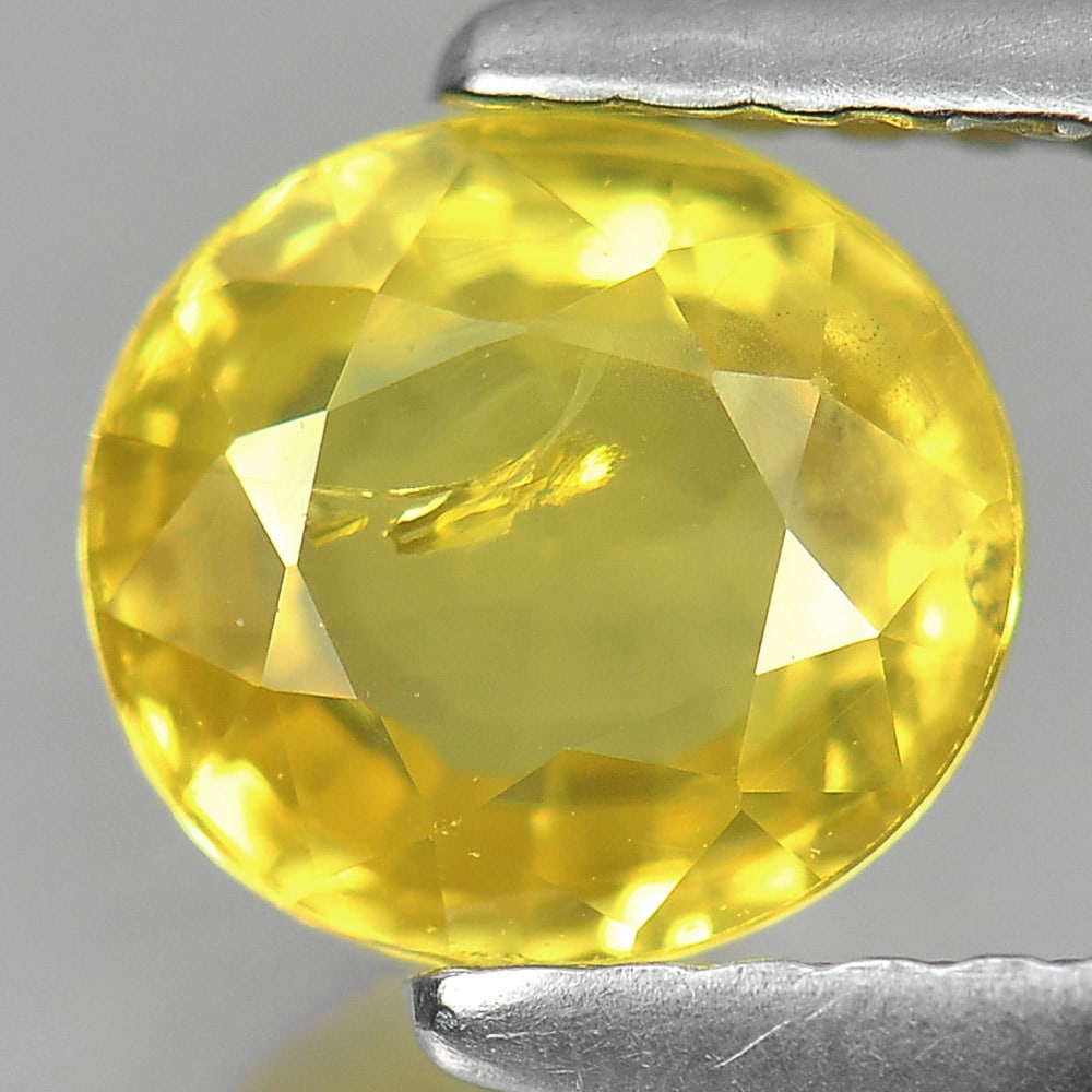 Natural Yellow Sapphire Gemstones 1.50 Ct. Oval Shape 6.7 x 6.2 Mm.: Product ID: 806139132 Product Name: Natural Yellow Sapphire Weight: 1.50 CT. Size: 6.7 x 6.2 x 3.8 MM. Shape: Oval Color: Yellow Clarity:SI1 Luster: Good Gems Origin: Thailand Treatment: Heated Crysta