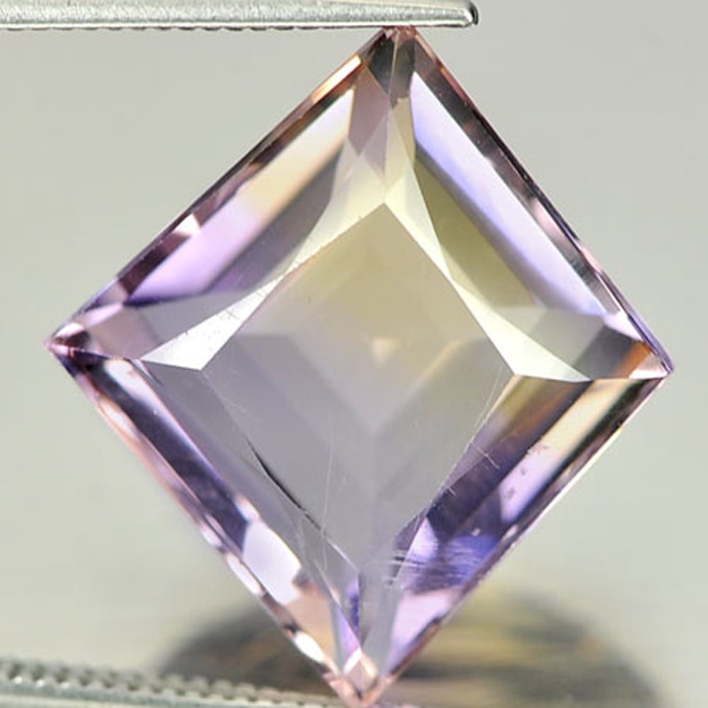 Natural Bi Color Ametrine Gemstones 8.62 Ct. Fancy Shape 17.4 x 15.7 Mm.: Product ID: 800407334 Product Name: Natural Ametrine Weight: 8.62 CT. Size: 17.4 x 15.7 x 7.5 MM. Shape: Fancy Color: Bi-Color Clarity:VSI Luster: Good Gems Origin: Bolivia Treatment: Unheated Crystal