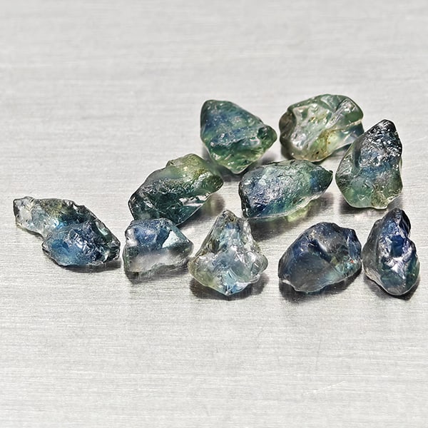 Natural Unheated Greenish Blue Sapphire Gemstones 3.00 Ct. 10 Pcs. Rough Shape Mixed Size: Product ID: 806162523 Product Name: Natural Green Sapphire Weight: 3.00 CT. Size: 6.5 x 2.6 x 2.6 to 3.5 x 2.7 x 2.4 MM. Shape: Rough Mixed Shape Color: Greenish Blue Clarity:VSI Luster: Good Gems Ori