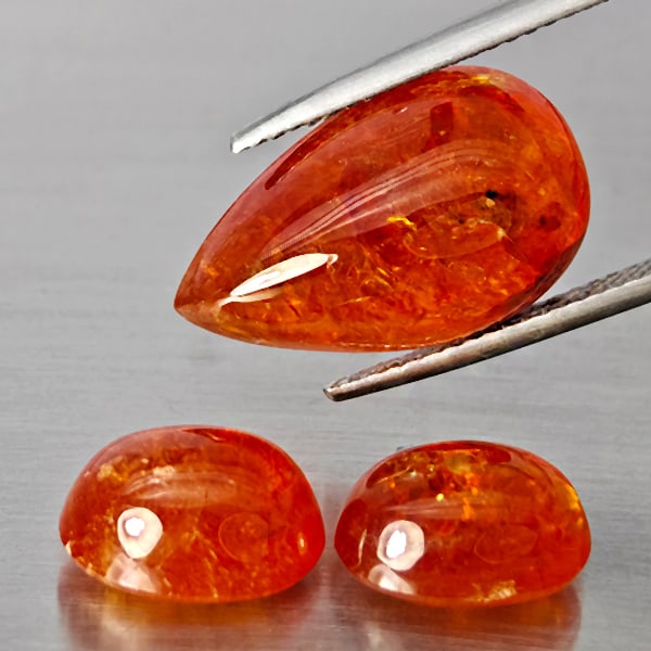 Natural Orangish Red Spessartine Garnet Gemstones 27.91 Ct. 3 Pcs. Mixed Cabochon Shape and Mixed: Product ID: 802938038 Product Name: Natural Garnet Weight: 27.91 CT. Size: 18.5 x 11.2 x 7.9 to 10.9 x 8.5 x 6 MM. Shape: Mixed Shape Color: Orangish Red Clarity:SI1 Luster: Good Gems Origin: Namibia 