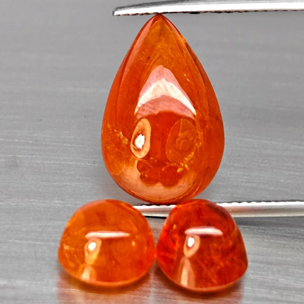 Natural Orangish Red Spessartine Garnet Gemstones 23.18 Ct. 3 Pcs. Mixed Cabochon Shape and Mixed: Product ID: 802938036 Product Name: Natural Garnet Weight: 23.18 CT. Size: 17.3 x 11.3 x 7 to 8.4 x 8.4 x 6.5 MM. Shape: Mixed Shape Color: Orangish Red Clarity:SI1 Luster: Good Gems Origin: Namibia T