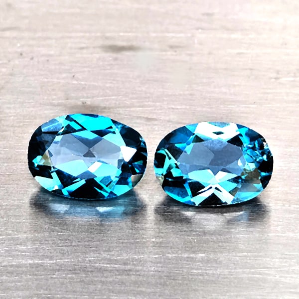Natural London Blue Topaz Gemstones 1.81 Ct. 2 Pcs. Oval Shape 7.2 x 5.1 Mm.: Product ID: 807169106 Product Name: Natural Blue Topaz Weight: 1.81 CT. Size: 7.2 x 5.1 x 3.1 MM. Shape: Oval Shape Color: London Blue Clarity:VSI - SI1 Luster: Good Gems Origin: Brazil Treatment: Tre