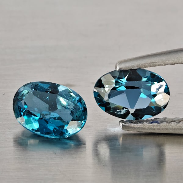 Natural London Blue Topaz Gemstones 1.95 Ct. 2 Pcs. Oval Shape 7 x 5.2 Mm.: Product ID: 807169111 Product Name: Natural Blue Topaz Weight: 1.95 CT. Size: 7 x 5.2 x 3.4 MM. Shape: Oval Shape Color: London Blue Clarity:VSI - SI1 Luster: Good Gems Origin: Brazil Treatment: Treat