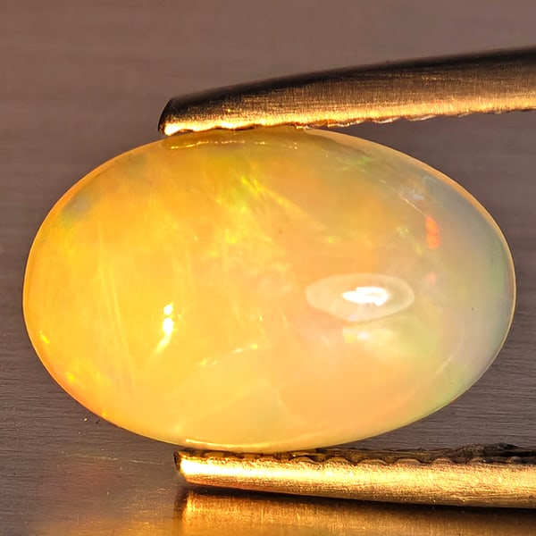 Natural Multi-Color Play Of Colour Opal Gemstones 1.66 Ct. Oval Cabochon Shape 11.8 x 8 Mm.: Product ID: 708700033 Product Name: Natural Opal Weight: 1.66 CT. Size: 11.8 x 8 x 4.3 MM. Shape: Oval Cabochon Color: Multi-Color Clarity:Opaque Luster: Good Gems Origin: Ethiopia Treatment: Unheated