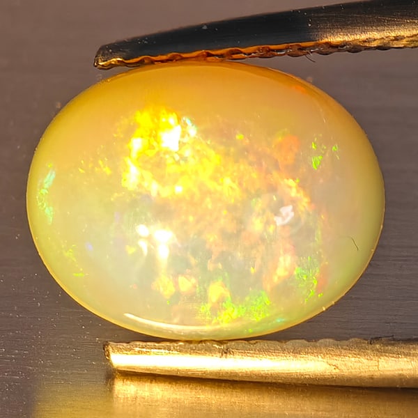 Natural Multi-Color Play Of Colour Opal Gemstone 2.26 Ct. Oval Cabochon Shape 12.2 x 9 Mm.: Product ID: 708700129 Product Name: Natural Opal Weight: 2.26 CT. Size: 12.2 x 9 x 4.5 MM. Shape: Oval Cabochon Color: Multi-Color Clarity:Opaque Luster: Good Gems Origin: Ethiopia Treatment: Unheated