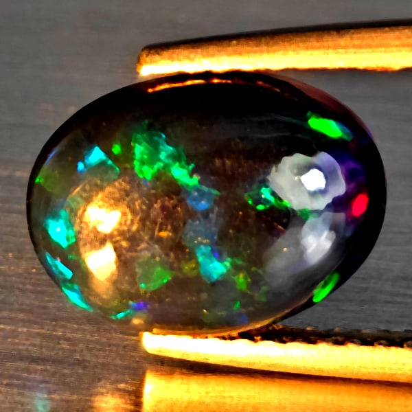 Natural Multi Color Play Of Colour Opal Gemstones 1.68 Ct. Oval Cabochon Shape 11.1 x 8.3 Mm.: Product ID: 818728468 Product Name: Natural Opal Weight: 1.68 CT. Size: 11.1 x 8.3 x 3.9 MM. Shape: Oval Cabochon Color: Multi-Color Clarity:Semi - Transparent Luster: Good Gems Origin: Ethiopia Treat