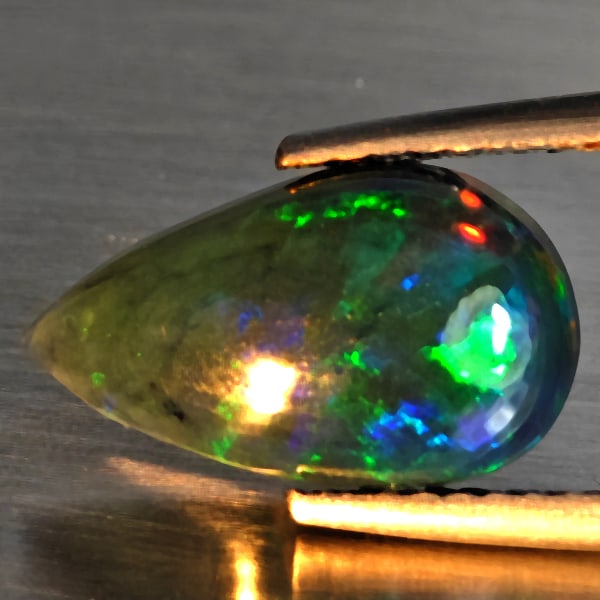Natural Multi Color Play Of Colour Opal Gemstones 1.65 Ct. Pear Cabochon Shape 12.7 x 7.8 Mm.: Product ID: 818728498 Product Name: Natural Opal Weight: 1.65 CT. Size: 12.7 x 7.8 x 4.2 MM. Shape: Oval Cabochon Color: Multi-Color Clarity:Semi - Transparent Luster: Good Gems Origin: Ethiopia Treat