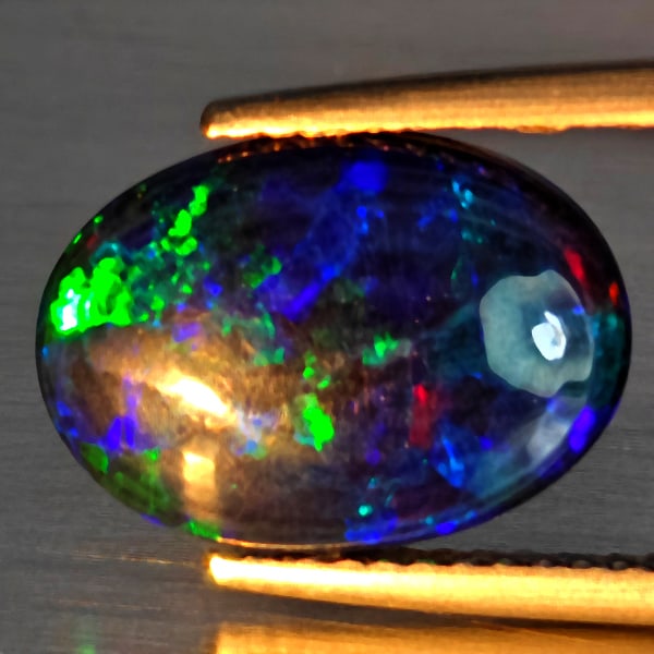 Natural Multi Color Play Of Colour Opal Gemstones 1.05 Ct. Oval Cabochon Shape 13 x 9.5 Mm.: Product ID: 818728481 Product Name: Natural Opal Weight: 1.05 CT. Size: 13 x 9.5 x 2.6 MM. Shape: Oval Cabochon Color: Multi-Color Clarity:Semi - Transparent Luster: Good Gems Origin: Ethiopia Treatme