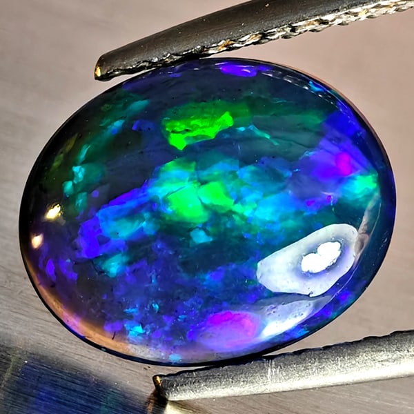 Natural Multi Color Play Of Colour Opal Gemstones 1.75 Ct. Oval Cabochon Shape 11.1 x 9.1 Mm.: Product ID: 818728479 Product Name: Natural Opal Weight: 1.75 CT. Size: 11.1 x 9.1 x 3.6 MM. Shape: Oval Cabochon Color: Multi-Color Clarity:Semi - Transparent Luster: Good Gems Origin: Ethiopia Treat