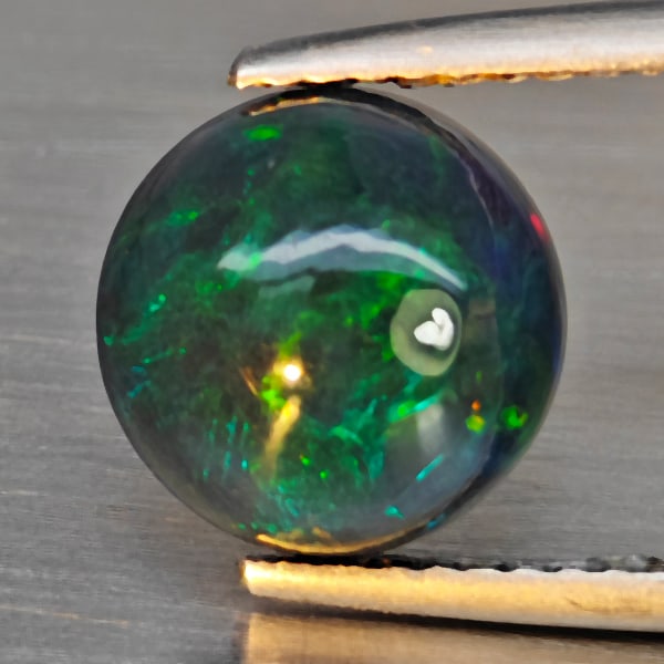 Natural Multi Color Play Of Color Rainbow Opal Gemstones 1.85 Ct. Round Cabochon Shape 9.1 Mm.: Product ID: 818728626 Product Name: Natural Opal Weight: 1.85 CT. Size: 9.1 x 9.1 x 5.3 MM. Shape: Round Cabochon Color: Multi-Color Clarity:Semi - Transparent Luster: Good Gems Origin: Ethiopia Treat
