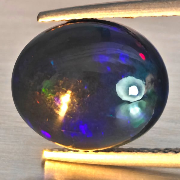 Natural Multi Color Play Of Color Rainbow Opal Gemstones 3.24 Ct. Oval Cabochon Shape12.6 x 10.8 Mm.: Product ID: 818728619 Product Name: Natural Opal Weight: 3.24 CT. Size: 12.6 x 10.8 x 5.1 MM. Shape: Oval Cabochon Color: Multi-Color Clarity:Semi - Transparent Luster: Good Gems Origin: Ethiopia Trea