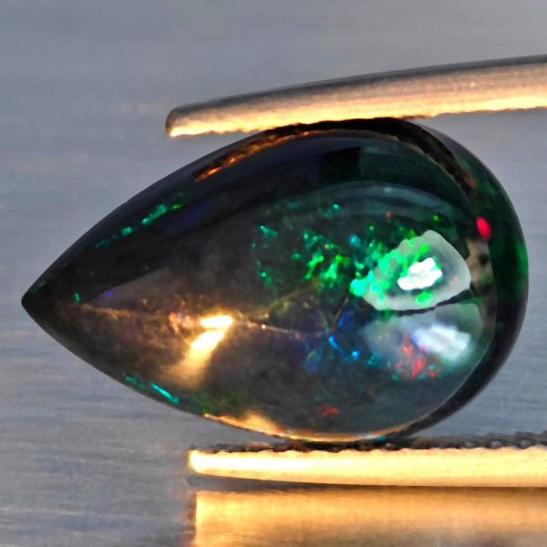 Natural Multi Color Play Of Colour Opal Gemstones 2.99 Ct. Pear Cabochon Shape 15.1 x 10 Mm.: Product ID: 818728502 Product Name: Natural Opal Weight: 2.99 CT. Size: 15.1 x 10 x 5.3 MM. Shape: Oval Cabochon Color: Multi-Color Clarity:Semi - Transparent Luster: Good Gems Origin: Ethiopia Treatm