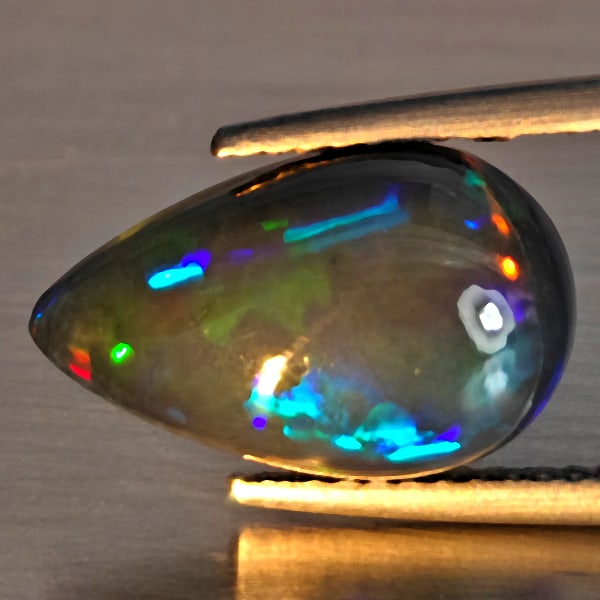 Natural Multi Color Play Of Colour Opal Gemstones 3.26 Ct. Pear Cabochon Shape 14.5 x 9 Mm.: Product ID: 818728566 Product Name: Natural Opal Weight: 3.26 CT. Size: 14.5 x 9 x 5.6 MM. Shape: Pear Cabochon Shape Color: Multi-Color Clarity:Semi - Transparent Luster: Good Gems Origin: Ethiopia T