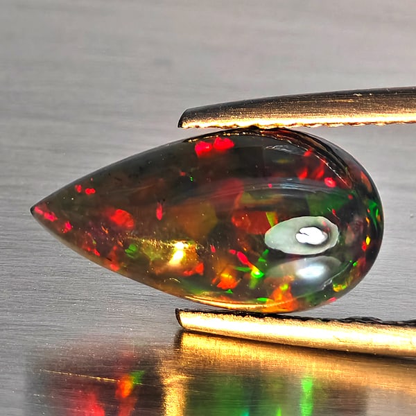 Natural Multi Color Play Of Color Rainbow Opal Gemstones 1.61 Ct. Pear Cabochon Shape 14.1 x 7.5 Mm.: Product ID: 818728635 Product Name: Natural Opal Weight: 1.61 CT. Size: 14.1 x 7.5 x 3.9 MM. Shape: Pear Cabochon Color: Multi-Color Clarity:Semi - Transparent Luster: Good Gems Origin: Ethiopia Treat