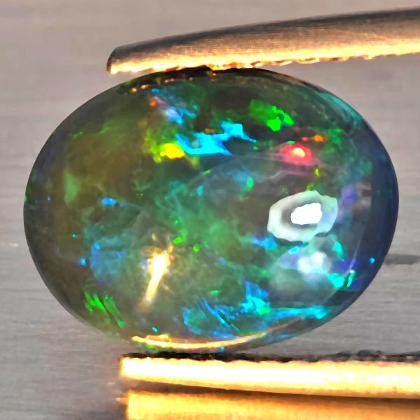 Natural Multi Color Play Of Color Rainbow Opal Gemstones 2.20 Ct. Oval Cabochon Shape 11.6 x 9 Mm.: Product ID: 818728623 Product Name: Natural Opal Weight: 2.20 CT. Size: 11.6 x 9 x 4.6 MM. Shape: Oval Cabochon Color: Multi-Color Clarity:Semi - Transparent Luster: Good Gems Origin: Ethiopia Treatme