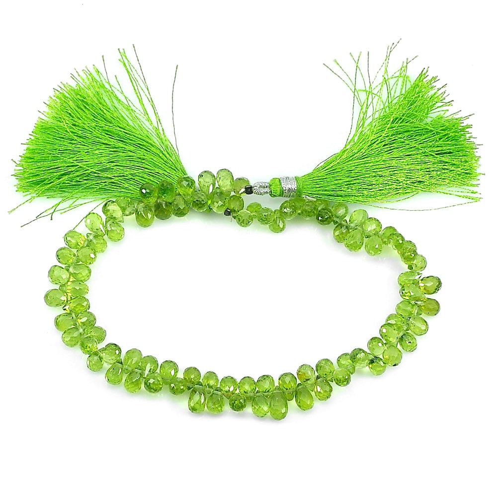 Natural Green Peridot Gemstones 88.10 Ct. Briolette Shape Beads 9 Inch.: Product ID: 805306807 Product Name: Natural Peridot Weight: 88.10 CT. Size: 9 Inch. / 5.8 x 4.1 MM. Shape: Briolette Color: Green Clarity:IF - VVS Luster: Good Gems Origin: Thailand Treatment: Unheate