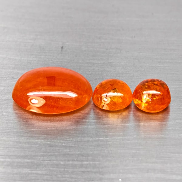 Natural Orangish Red Spessartine Garnet Gemstones 14.67 Ct. 3 Pcs. Mixed Cabochon Shape Mixed Size: Product ID: 802938004 Product Name: Natural Garnet Weight: 14.67 CT. Size: 14.3 x 11.7 x 5.6 to 7 x 7 x 4.9 MM. Shape: Mixed Cabochon Color: Orangish Red Clarity:SI1 Luster: Good Gems Origin: Namibia 
