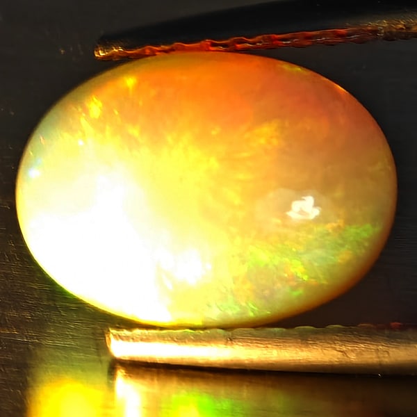 Natural Multi-Color Play Of Colour Opal Gemstone 2.05 Ct. Oval Cabochon Shape 10.7 x 8 Mm.: Product ID: 708700165 Product Name: Natural Opal Weight: 2.05 CT. Size: 10.7 x 8 x 4.7 MM. Shape: Oval Cabochon Color: Multi-Color Clarity:Opaque Luster: Good Gems Origin: Ethiopia Treatment: Unheated