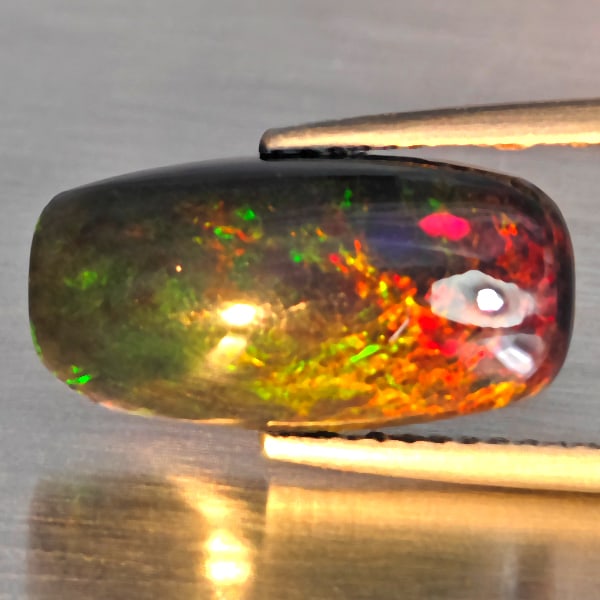 Natural Multi Color Play Of Color Rainbow Opal Gemstones 2.67 Ct. Cusihon Cabochon Shape16.4 x 8.4: Product ID: 818728656 Product Name: Natural Opal Weight: 2.67 CT. Size: 16.4 x 8.4 x 4.5 MM. Shape: Cushion Cabochon Color: Multi-Color Clarity:Semi - Transparent Luster: Good Gems Origin: Ethiopia Tr