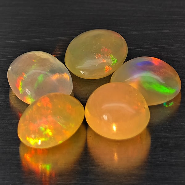 Natural Multi Color Opal 3.11 Ct. 5 Pcs Oval Cabochon Shape 6.7 x 5.5 Mm Gemstones: Product ID: 818728421 Product Name: Natural Opal Weight: 3.11 CT. Size: 6.7 x 5.5 x 3.7 MM. Shape: Oval Cabochon Color: Multi-Color Clarity:Semi - Transparent Luster: Good Gems Origin: Ethiopia Treatm