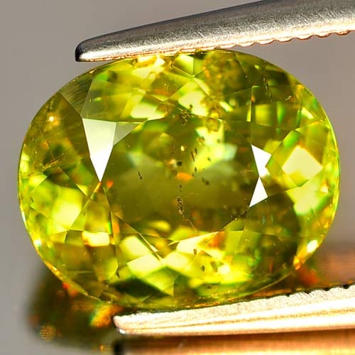 Natural Intense Green Titanium Sphene Red Spark 3.56 Ct. Oval Shape 10 x 8 Mm.: Product ID: 806502884 Product Name: Natural Sphene Weight: 3.56 CT. Size: 10 x 8 x 5.2 MM. Shape: Oval Color: Intense Green With Red Spark Clarity:SI Luster: Adamantine Gems Origin: Mardagascar Treatm