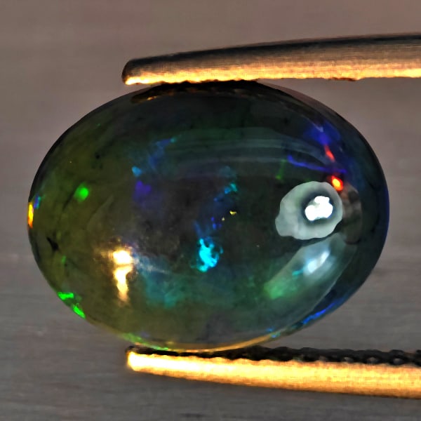 Natural Multi Color Play Of Color Rainbow Opal Gemstones 2.21 Ct. Oval Cabochon Shape12.3 x 9.4 Mm.: Product ID: 818728621 Product Name: Natural Opal Weight: 2.21 CT. Size: 12.3 x 9.4 x 4.5 MM. Shape: Oval Cabochon Color: Multi-Color Clarity:Semi - Transparent Luster: Good Gems Origin: Ethiopia Treat