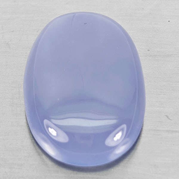Natural Lavender Chalcedony Gemstones 50.06 Ct. Oval Cabochon Shape 32 x 22 Mm.: Product ID: 801502646 Product Name: Natural Weight: 50.06 CT. Size: 32 x 22 x 9 MM. Shape: Oval Cabochon Color: Lavender Clarity:Semi - Transparent Luster: Good Gems Origin: Russia Treatment: Unheated