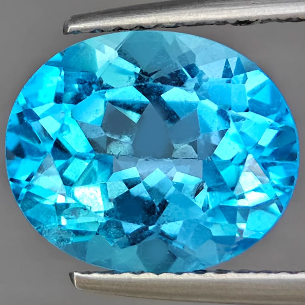 Natural Swiss Blue Topaz Gemstone 5.83 Ct. Oval Shape 12.2 x 10.3 Mm.: Product ID: 807169023 Product Name: Natural Blue Topaz Weight: 5.83 CT. Size: 12.2 x 10.3 x 6.6 MM. Shape: Oval Shape Color: Swiss Blue Clarity:VSI Luster: Good Gems Origin: Brazil Treatment: Treated 