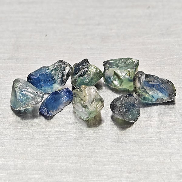 Natural Greenish Blue Sapphire Gemstones 1.87 Ct. 8 Pcs. Rough Shape Mixed Size: Product ID: 806162524 Product Name: Natural Green Sapphire Weight: 1.87 CT. Size: 3 x 2.8 x 2.2 to 4.6 x 2.7 x 2.4 MM. Shape: Rough Mixed Shape Color: Greenish Blue Clarity:VSI Luster: Good Gems Origi