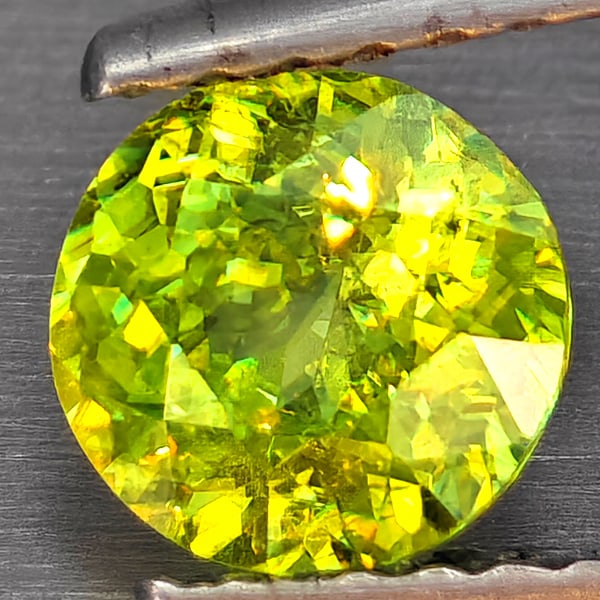 Natural Multi-Color Sphene Gemstones With Rainbow Spark 0.72 Ct. Round Shape 5.8 Mm.: Product ID: 806509287 Product Name: Natural Sphene Weight: 0.72 CT. Size: 5.8 x 5.8 x 3.2 MM. Shape: Round Shape Color: Multi-Color Clarity:SI1 Luster: Good Gems Origin: Madagascar Treatment: Unheated
