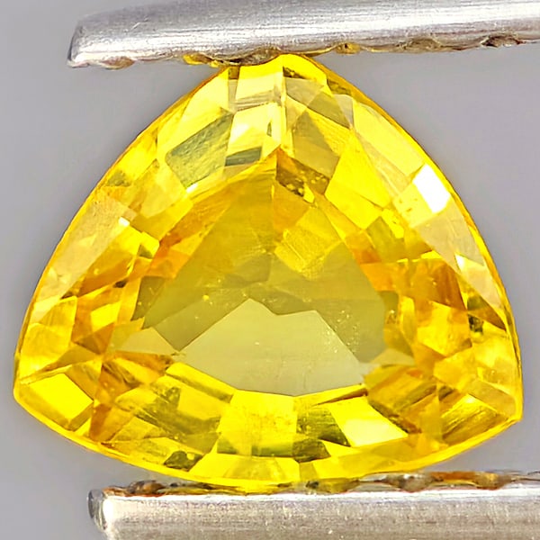 Natural Yellow Sapphire Gemstones 0.56 Ct. Trilliant Shape 5.5 x 4.9 Mm.: Product ID: 806162851 Product Name: Natural Yellow Sapphire Weight: 0.56 CT. Size: 5.5 x 4.9 x 2.5 MM. Shape: Trilliant Color: Yellow Clarity:VSI Luster: Good Gems Origin: Thailand Treatment: Heated C