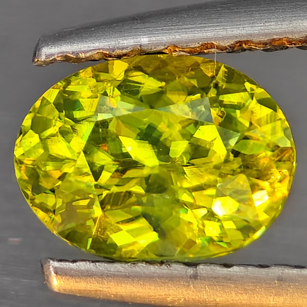 Natural Multi-Color Sphene Gemstones With Rainbow Spark 0.81 Ct. Oval Shape 6.8 x 5 Mm.: Product ID: 806509271 Product Name: Natural Sphene Weight: 0.81 CT. Size: 6.8 x 5 x 3.7 MM. Shape: Oval Color: Multi-Color Clarity:SI1 Luster: Good Gems Origin: Madagascar Treatment: Unheated Crystal 