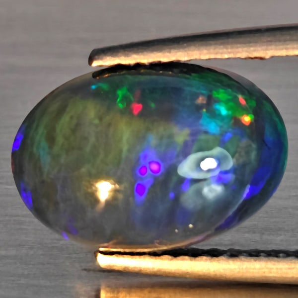 Natural Multi Color Play Of Color Rainbow Opal Gemstones 2.39 Ct. Oval Cabochon Shape 12.4 x 8.6 Mm.: Product ID: 818728611 Product Name: Natural Opal Weight: 2.39 CT. Size: 12.4 x 8.6 x 5.1 MM. Shape: Oval Cabochon Color: Multi-Color Clarity:Semi - Transparent Luster: Good Gems Origin: Ethiopia Treat