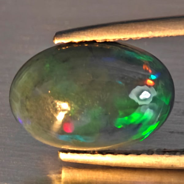 Natural Multi Color Play Of Color Rainbow Opal Gemstones 1.79 Ct. Oval Cabochon Shape 12.4 x 8.5 Mm.: Product ID: 818728614 Product Name: Natural Opal Weight: 1.79 CT. Size: 12.4 x 8.5 x 4 MM. Shape: Oval Cabochon Color: Multi-Color Clarity:Semi - Transparent Luster: Good Gems Origin: Ethiopia Treatme