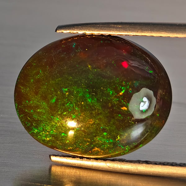 Natural Multi Color Play Of Color Rainbow Opal Gemstones 6.00 Ct. Oval Cabochon Shape16.9 x 13.4 Mm.: Product ID: 818728629 Product Name: Natural Opal Weight: 6.00 CT. Size: 16.9 x 13.4 x 5.6 MM. Shape: Oval Cabochon Color: Multi-Color Clarity:Semi - Transparent Luster: Good Gems Origin: Ethiopia Trea