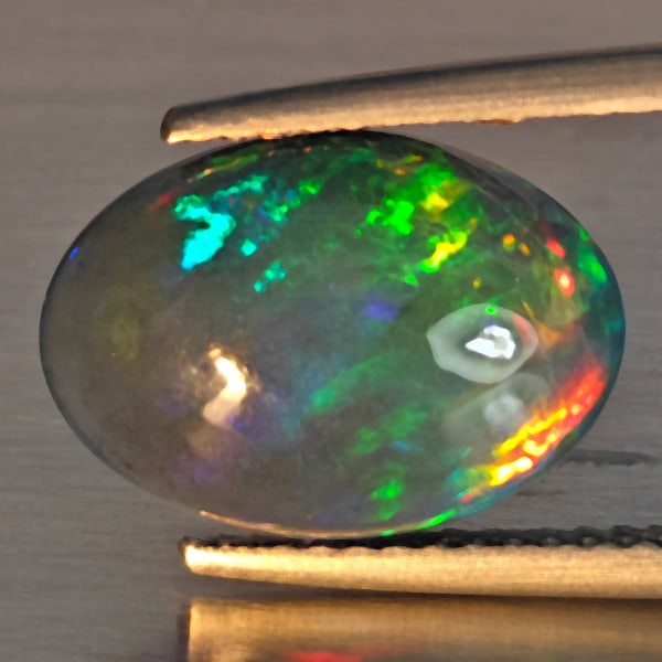 Natural Multi Color Play Of Color Rainbow Opal Gemstones 2.47 Ct. Oval Cabochon Shape 13.2 x 9.4 Mm.: Product ID: 818728616 Product Name: Natural Opal Weight: 2.47 CT. Size: 13.2 x 9.4 x 4.3 MM. Shape: Oval Cabochon Color: Multi-Color Clarity:Semi - Transparent Luster: Good Gems Origin: Ethiopia Treat