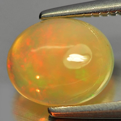 Natural Multi Color Play Of Colour Opal Gemstones 0.77 Ct. Oval Cabochon Shape 7.8 x 6.3 Mm.: Product ID: 818726042 Product Name: Natural Opal Weight: 0.77 CT. Size: 7.8 x 6.3 x 3.2 MM. Shape: Oval Cabochon Color: Multi Color Clarity:Semi - Transparent Luster: Strong Iridescent Gems Origin: Et