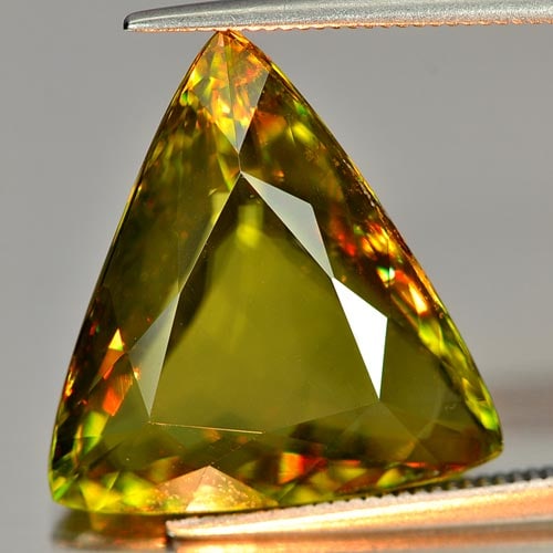 Natural Multi Color Sphene Gemstones 12.99 Ct. Trilliant Shape 18 x 16.6 Mm.: Product ID: 806505709 Product Name: Natural Sphene Weight: 12.99 CT. Size: 18 x 16.6 x 7 MM. Shape: Trilliant Color: Multi Color With Red Spark Clarity:SI Luster: Adamantine Gems Origin: Madagascar Tr