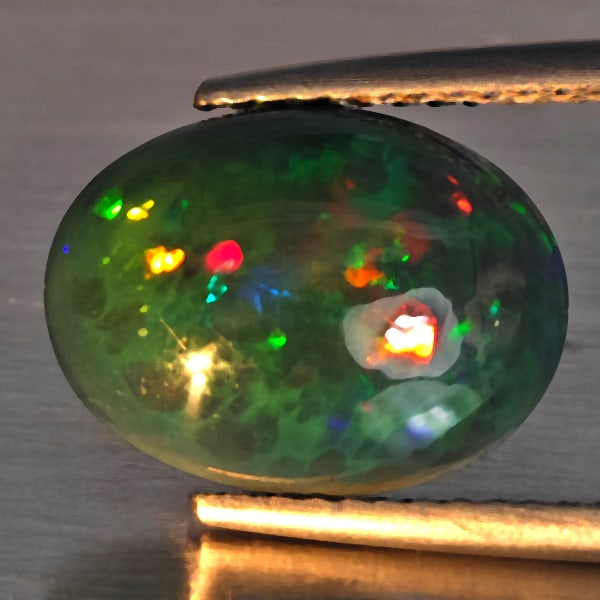 Natural Multi Color Play Of Color Rainbow Opal Gemstones 2.08 Ct. Oval Cabochon Shape 12.5 x 9.5 Mm.: Product ID: 818728612 Product Name: Natural Opal Weight: 2.08 CT. Size: 12.5 x 9.5 x 4.3 MM. Shape: Oval Cabochon Color: Multi-Color Clarity:Semi - Transparent Luster: Good Gems Origin: Ethiopia Treat