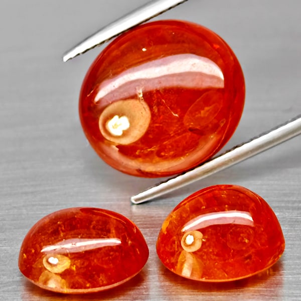 Natural Orange Spessartine Garnet Gemstones 30.36 Ct. 3 Pcs. Oval Cabochon Shape and Mixed Size: Product ID: 802938034 Product Name: Natural Garnet Weight: 30.36 CT. Size: 15.1 x 13.1 x 7.2 to 11 x 9.1 x 7.3 MM. Shape: Mixed Shape Color: Orangish Red Clarity:SI1 Luster: Good Gems Origin: Namibia 