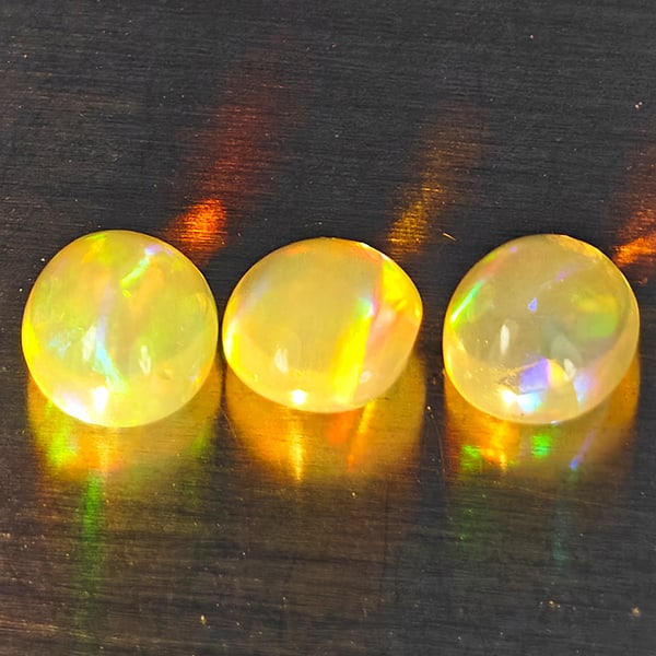 Natural Multi-Color Play Of Colour Opal Gemstones 1.07 Ct. 3 Pcs. Oval Cabochon Shape 5.2 x 4.5 Mm.: Product ID: 818728302 Product Name: Natural Opal Weight: 1.07 CT. Size: 5.2 x 4.5 x 3 MM. Shape: Oval Cabochon Color: Multi-Color Clarity:None Luster: Good Gems Origin: Ethiopia Treatment: Unheated Cr