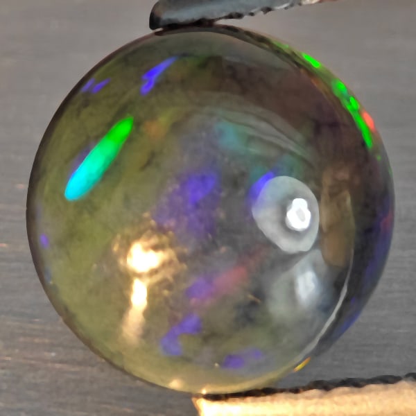 Natural Multi Color Opal Gemstones 2.33 Ct. Round Cabochon Shape 10.3 Mm.: Product ID: 818728542 Product Name: Natural Opal Weight: 2.33 CT. Size: 10.3 x 5.1 MM. Shape: Round Cabochon Color: Multi-Color Clarity:Semi - Transparent Luster: Good Gems Origin: Ethiopia Treatment: