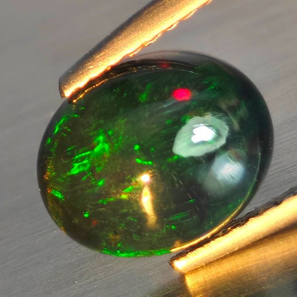 Natural Multi Color Play Of Color Rainbow Opal Gemstones 1.90 Ct. Oval Cabochon Shape 10.1 x 8.3 Mm.: Product ID: 818728628 Product Name: Natural Opal Weight: 1.90 CT. Size: 10.1 x 8.3 x 5.1 MM. Shape: Oval Cabochon Color: Multi-Color Clarity:Semi - Transparent Luster: Good Gems Origin: Ethiopia Treat