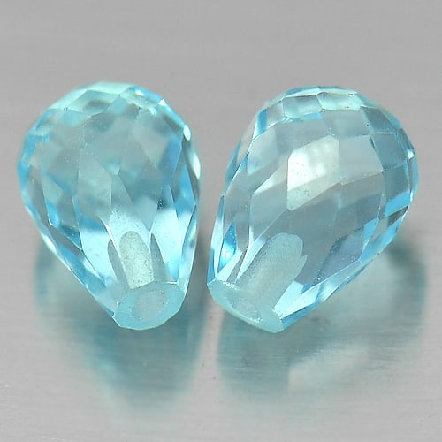 Natural Swiss Blue Topaz Gemstones 3.41Ct. Pair Briolette with Drilled Cut 7.3 x 5.2 Mm.: Product ID: 807153912 Product Name: Natural Blue Topaz Weight: 3.41 CT. Size: 7.3 x 5.2 x 5.2 MM. Shape: Briolette with Drilled Color: Blue Clarity:VVS Luster: Good Gems Origin: Brazil Treatment: Trea