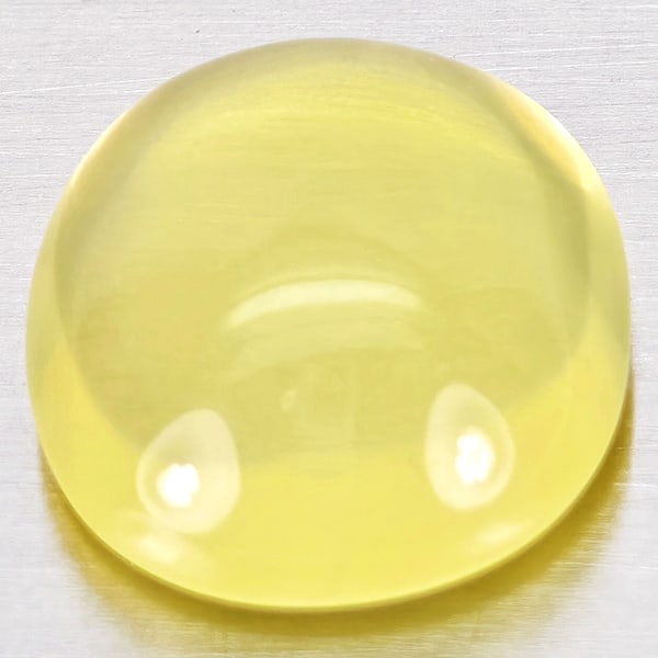 Natural Yellow Quartz Gemstones 6.78 Ct. Oval Cabochon Shape 13.1 x 12 Mm.: Product ID: 805530005 Product Name: Natural Quartz Weight: 6.78 CT. Size: 13.1 x 12 x 6.3 MM. Shape: Oval Cabochon Color: Yellow Lemon Clarity:Semi - Transparent Luster: Good Gems Origin: Brazil Treat