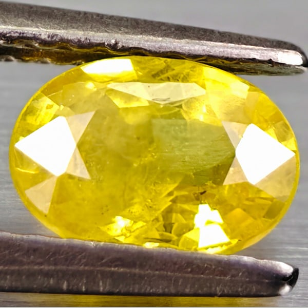 Natural Yellow Sapphire Gemstones 0.91 Ct. Oval Shape 6.8 x 5 Mm.: Product ID: 106116044 Product Name: Natural Yellow Sapphire Weight: 0.91 CT. Size: 6.8 x 5 x 3 MM. Shape: Oval Color: Yellow Clarity:VSI Luster: Good Gems Origin: Thailand Treatment: Heated Crystal St