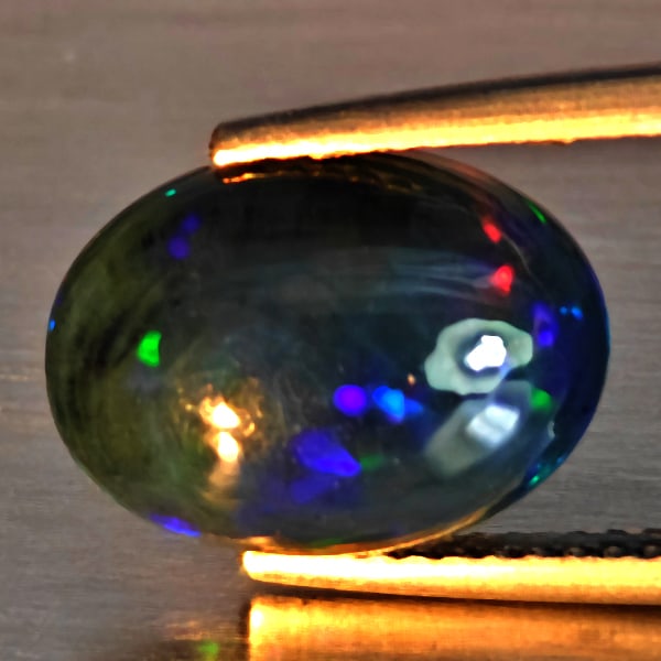 Natural Multi Color Play Of Colour Opal Gemstones 3.04 Ct. Oval Cabochon Shape 12.5 x 9.2 Mm.: Product ID: 818728605 Product Name: Natural Opal Weight: 3.04 CT. Size: 12.5 x 9.2 x 5.7 MM. Shape: Oval Cabochon Shape Color: Multi-Color Clarity:Semi - Transparent Luster: Good Gems Origin: Ethiopia