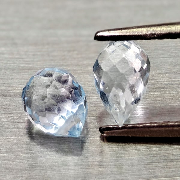 Natural Sky Blue Topaz Gemstones 1.45 Ct. 2 Pcs. Briolette With Drilled: Product ID: 807167996 Product Name: Natural Blue Topaz Weight: 1.45 CT. Size: 5.9 x 4.2 x 4.2 to 5.7 x 3.9 x 3.9 MM. Shape: Briolette With Drilled Color: Sky Blue Clarity:VSI Luster: Good Gems Origin: