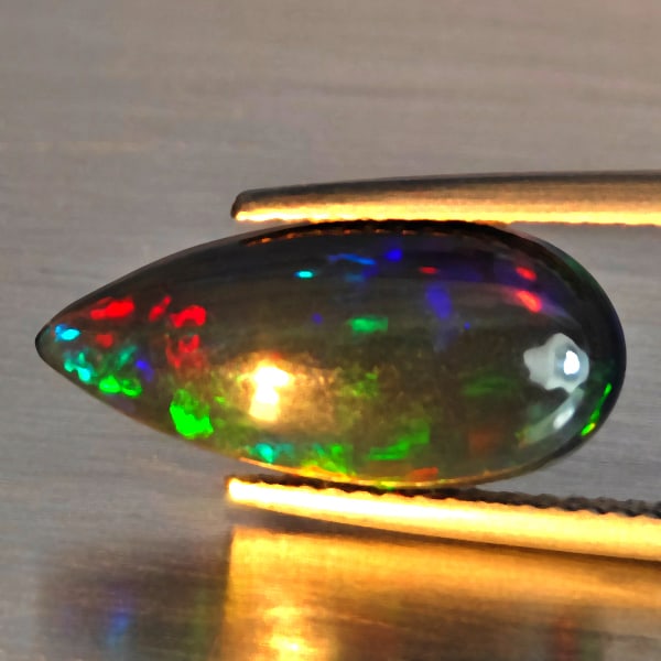 Natural Multi Color Play Of Colour Opal Gemstones 2.63 Ct. Pear Cabochon Shape 17 x 8 Mm.: Product ID: 818728558 Product Name: Natural Opal Weight: 2.63 CT. Size: 17 x 8 x 4.4 MM. Shape: Pear Cabochon Shape Color: Multi-Color Clarity:Semi - Transparent Luster: Good Gems Origin: Ethiopia Tre