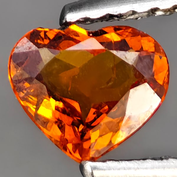 Natural Reddish Orange Spessartine Garnet Gemstones 0.55 Ct. Heart Shape 5.7 x 5 Mm.: Product ID: 802937848 Product Name: Natural Spessartine Weight: 0.55 CT. Size: 5.7 x 5 x 2.6 MM. Shape: Heart Shape Color: Reddish Orange Clarity:VVS - VSI Luster: Good Gems Origin: Namibia Treatment: